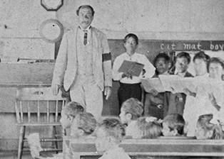 A black and white image of a man surrounded by children