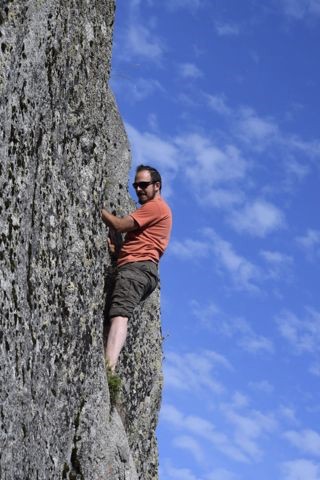 Man climbing up rock face