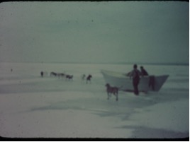 People move a boat across ice