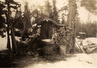 A man stands over a pot