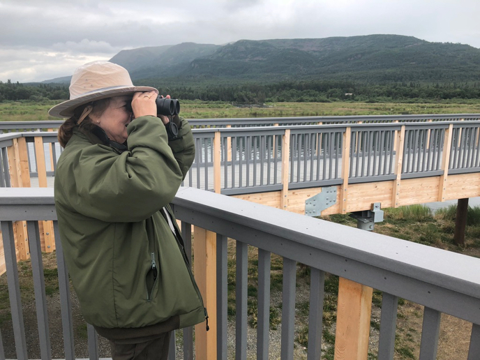 park ranger uses binoculars 