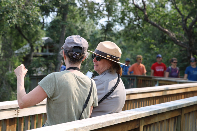 Chris answers a visitor's questions at Brooks Falls. park ranger speaking with visitor