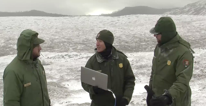 Rangers standing on snowy mountain top