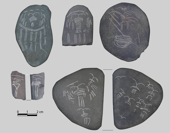 Incised pebbles with enhanced etchings Incised pebbles with enhanced etchings