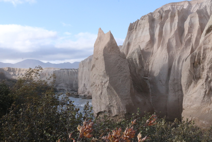 Wall of volcanic ash with river at center