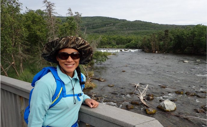 Person standing on wildlife viewing platform near river