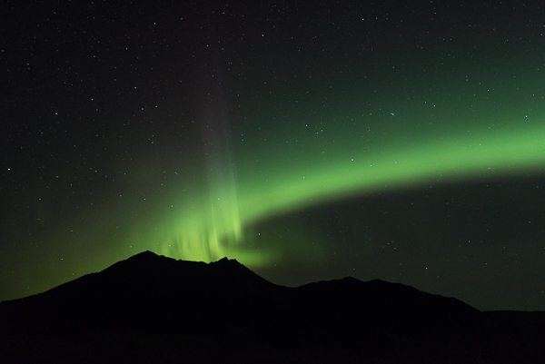 Aurora Borealis over Katolinat Green Light over Pointed Mountain Silhouette