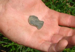 This side notched projectile point has an impact fracture at the tip.