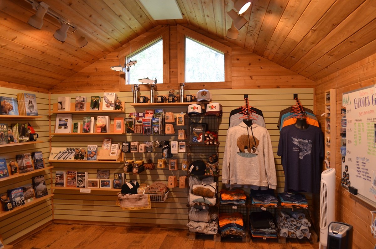 sales area that has shirts, books, mugs and other items