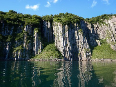 Columnar rocks rise out of the water