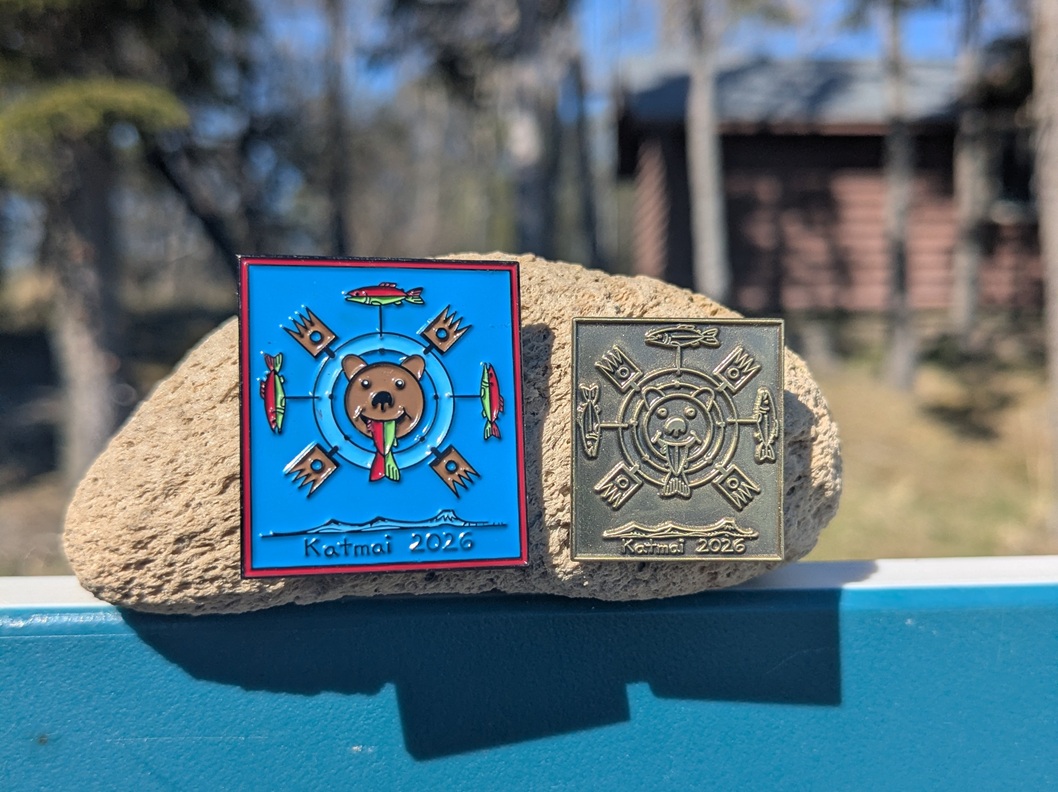 Bear pin on display with Brooks Camp visitor center in background