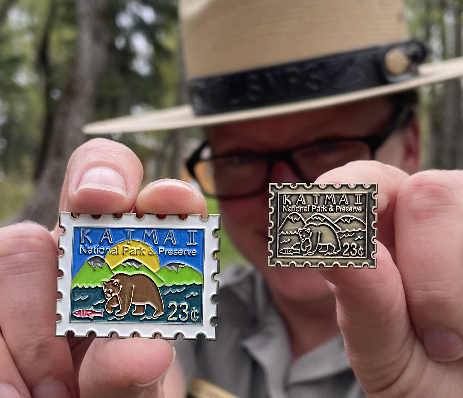 2023 Bear Pins A ranger holds pins shaped like stamps