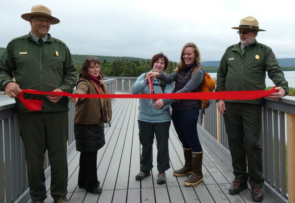 cutting the red ribbon across bridge walkway