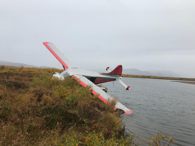 Plane Crash in Katmai National Preserve A small airplane hanging off of a riverbank