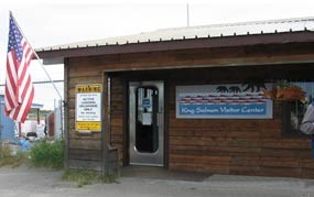 Wood sided structure with King Salmon Visitor Center sign to right of door.