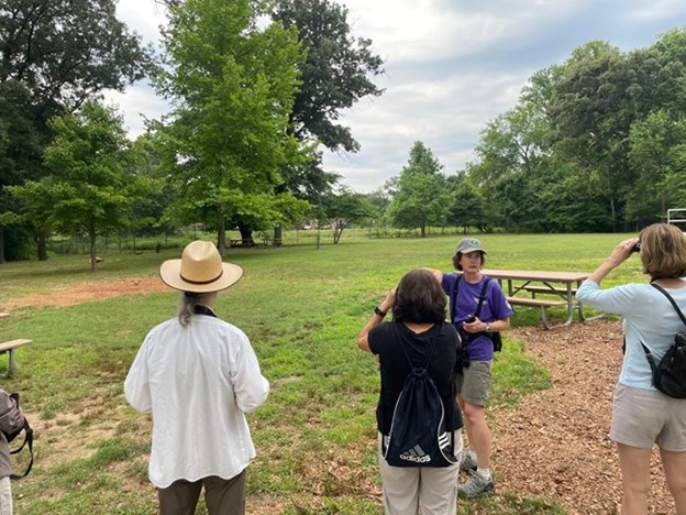 Local volunteer and expert birder Molly leads a bird walk around the gardens.