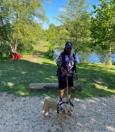 A woman walks her dog in the park.