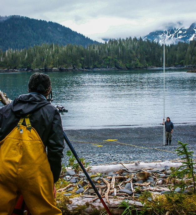 Researchers mapping a remote coastal beach containing archaeological remains. Photo//NPS