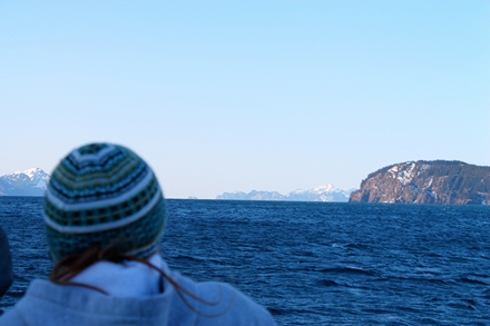 Student gazing out into the fjord from a boat.