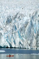 Kayaker in front of a tidewater glacier.