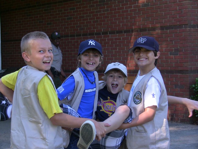Four kids laughing and smiling for the camera