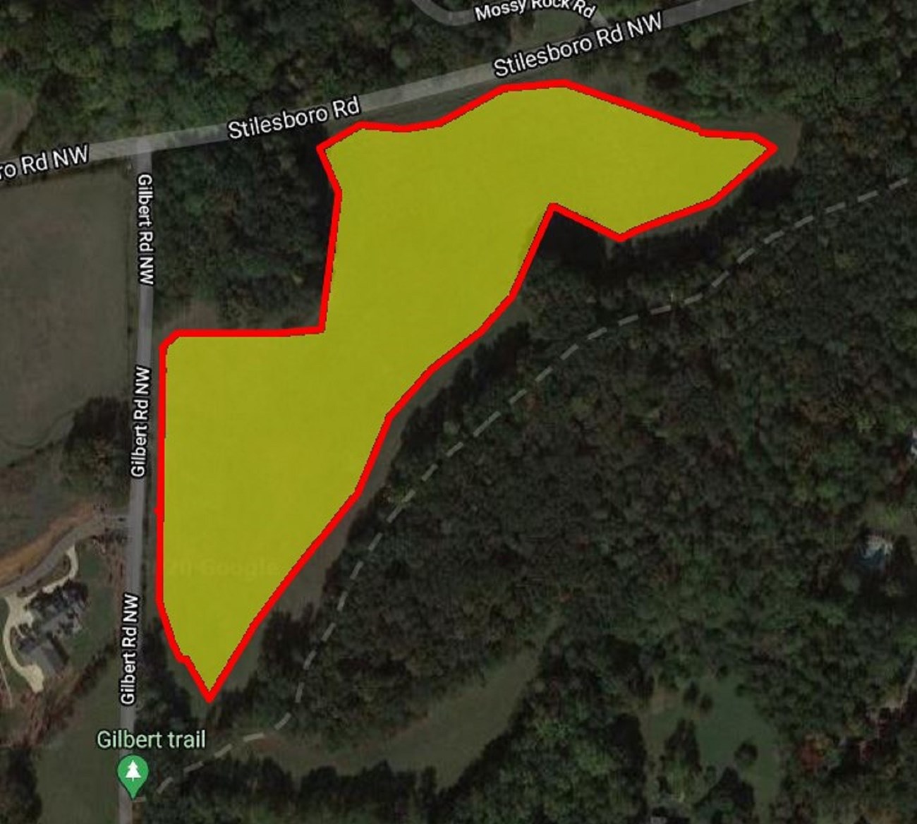 Yellow highlights a narrow diaganol field adjacent to and below the intersection of Stiesboro Rd  and Gilbert Rd NW. The Gilbert trail is parallel to and right of the field.