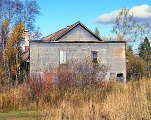A dilapidated buliding that reads "Co-op Hal"