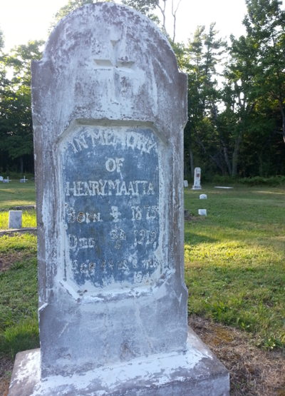 A tall, worn grave marker.