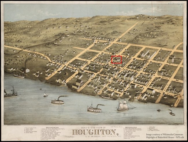 An illustrated map of a town with buildings next to a body of water.