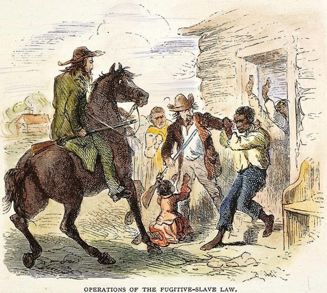 Two white men with guns pull an African-American man forcibly from his home.