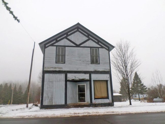 A dilapidated two-story building.