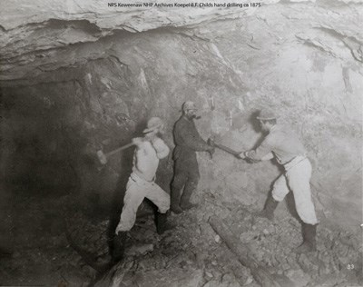 Hand drilling in a copper mine.