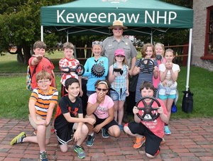 A group of students with park ranger smile for a photograph.