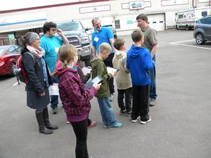 A group of students listens to a speaker.