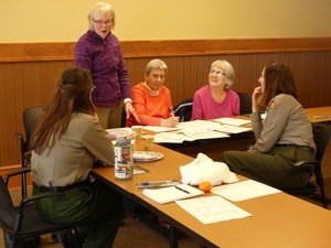 A group of adults work together on a lesson plan.