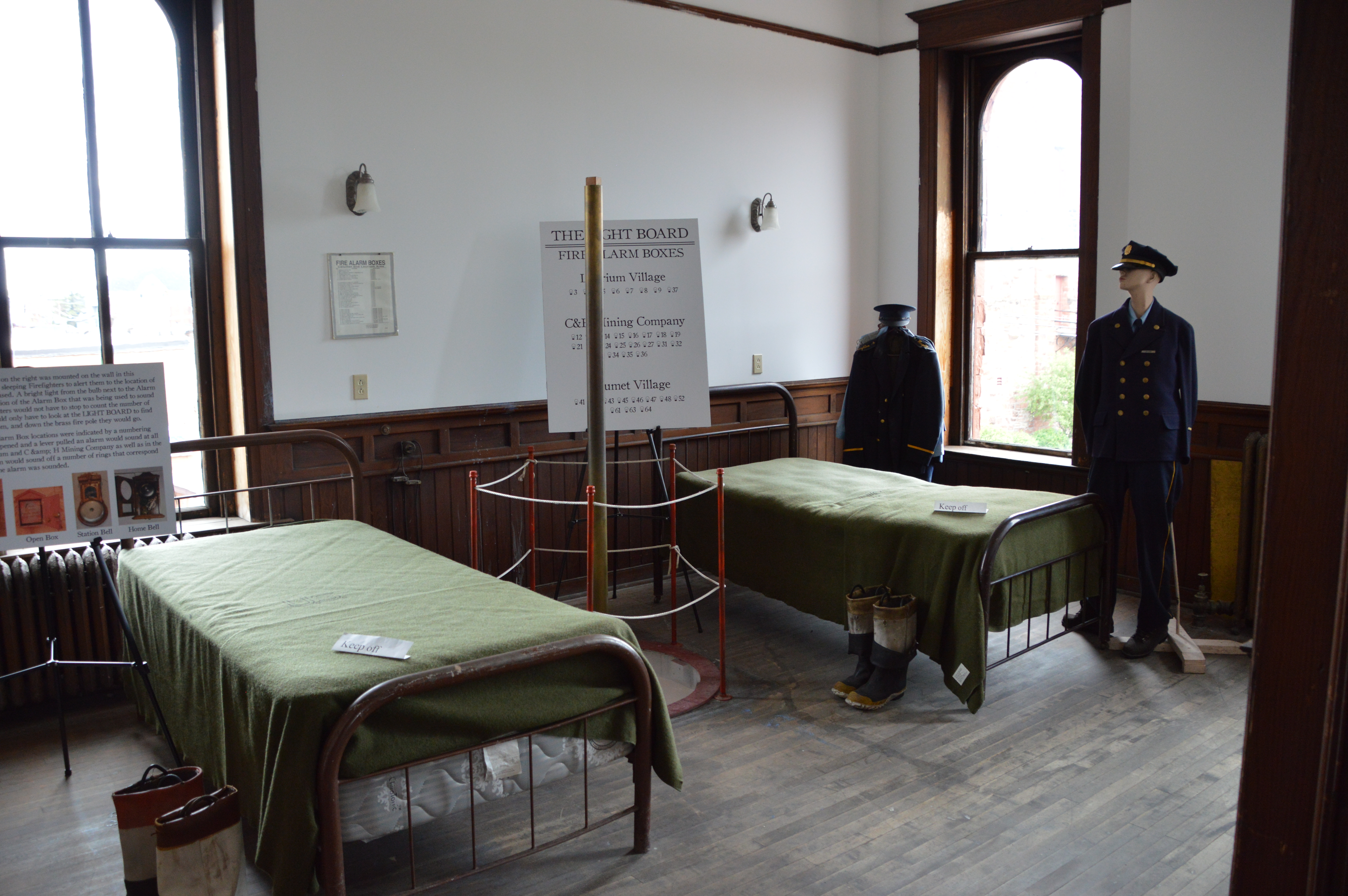 Two small beds with a firepole between them