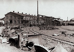 Historic photo: Scrap machinery and parts lie outside the closed Calumet & Hecla Foundry.