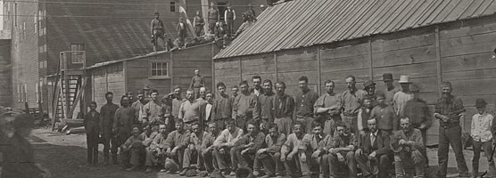 Historic photo: Mine workers pose outside the Hecla Mining Company Historic photo: Mine workers pose outside the Hecla Mining Company