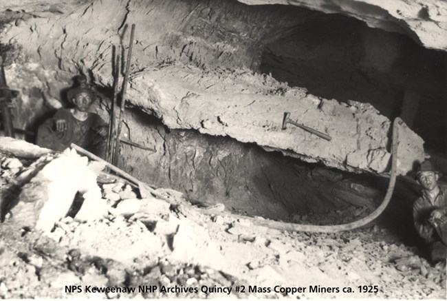 Quincy miners pose for a photo with a large piece of copper.