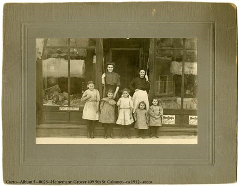Women standing in front of a storefront