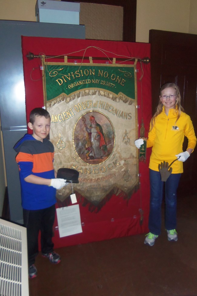 Jack and Maggie Haeussler are pictured here in March of 2015 with an Ancient Order of Hibernian lodge banner and other material they helped salvage from the attic of the former Hibernian Hall building in Hancock.