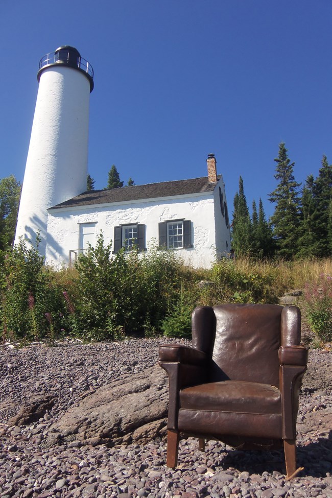 A leather armchair once used in the house at the Edison Fishery is seen on the beach at the Rock Harbor Lighthouse, awaiting transportation to the LSCMC’s Houghton Museum Storage Facility.