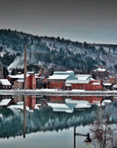 historic industrial buildings sit on a snowy landscape