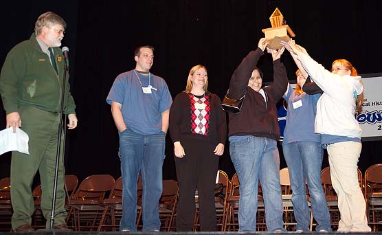 Winning team members Jessica Budreau, Ashley Shalifoe, and Denise Swift hoist the Smackdown Trophy.