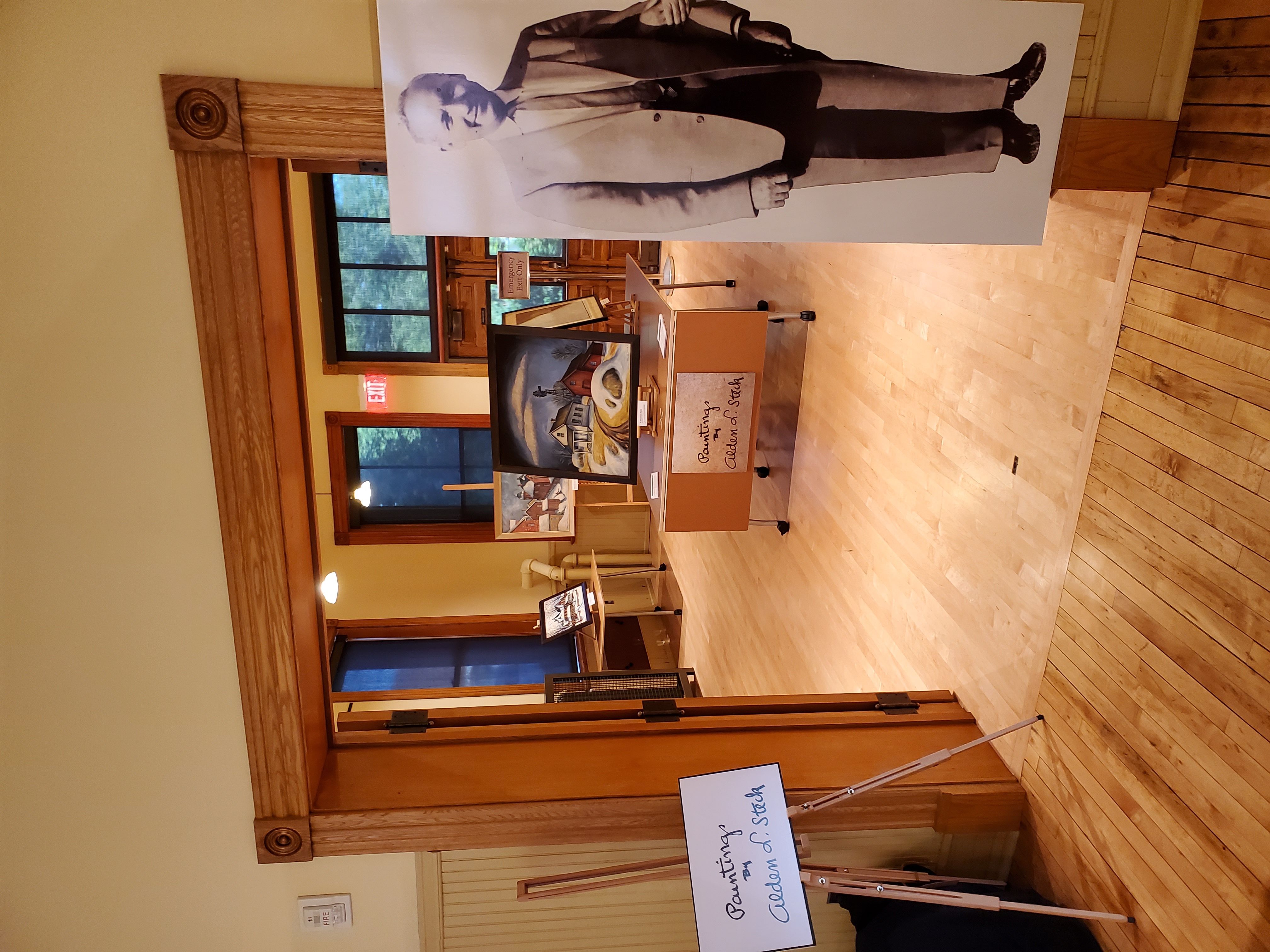 A photo exhibit in a historic building. A historic image of an artist introduces an exhibit at the Calumet Visitor Center.