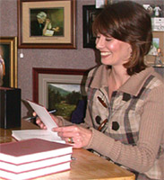 Author Angela Johnson signs copies of her book Seasons of Faith: a Walk through the History of the Roman Catholic Diocese of Marquette, 1900-2000.