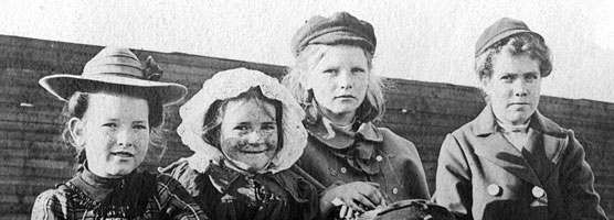 A group of immigrant children pose for a photographer. LaMuth Collection.