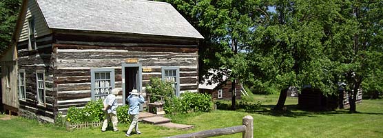 Visitors troll by the cabins at Old Victoria