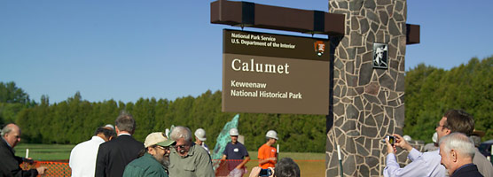 Area residents, park partners and staff gather to celebrate the completion of the new park sign.