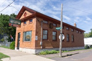 The red exterior of the Copper Range Historical Museum.